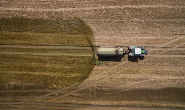 Field fertilization Aerial view of a tractor fertilizing a field