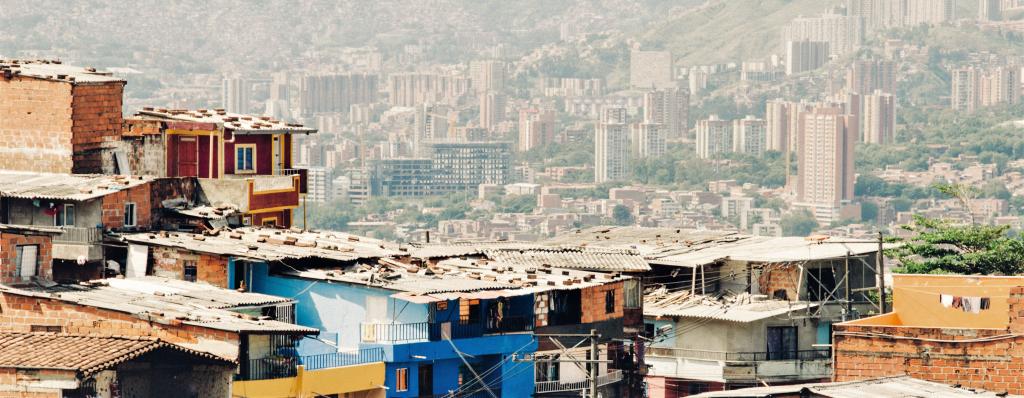 shanty town versus central town buildings in the background