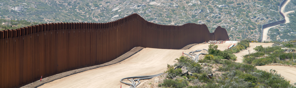 view of a militarized border and the wall dividing